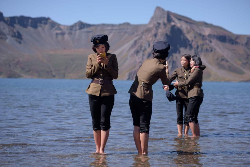 North Korean students posing for pictures at a lake near Samjiyon