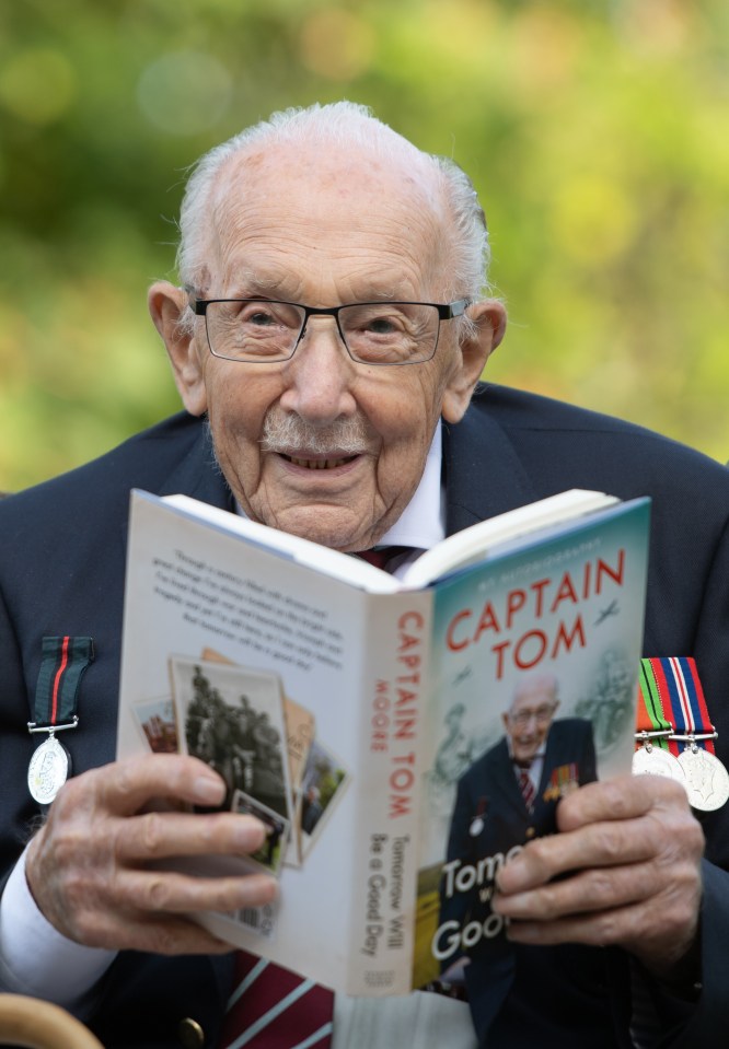 Captain Tom Moore holding his autobiography, "Tomorrow Will Be A Good Day."