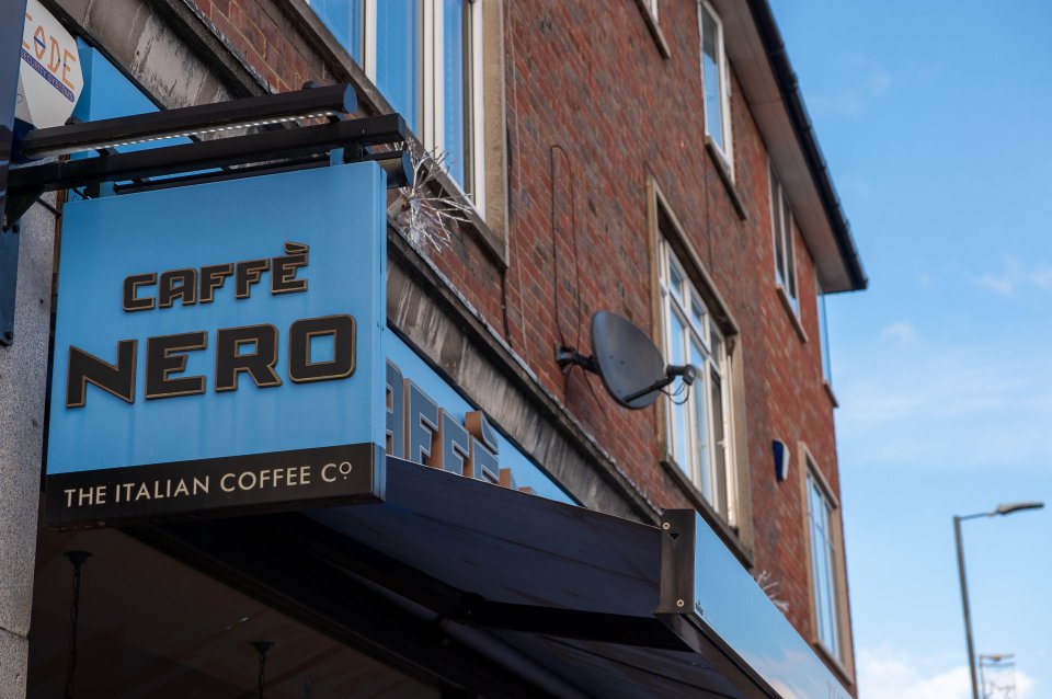 Caffè Nero sign on a brick building.