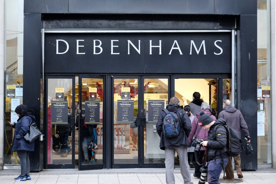 Shoppers entering a Debenhams department store.