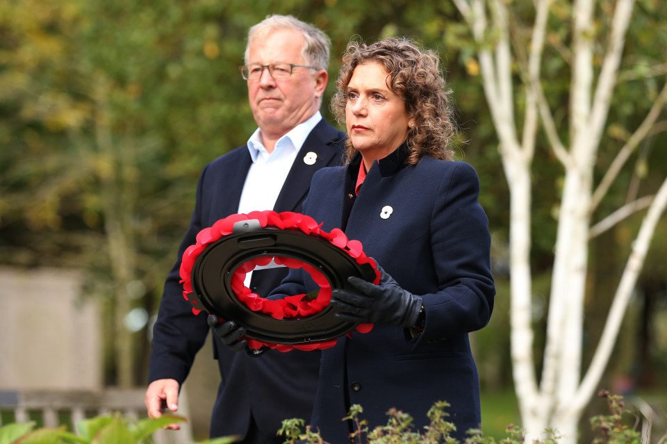 Hannah Ingram-Moore and her husband placing a wreath at a memorial.