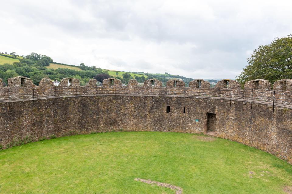 Top of Totnes Castle in Devon, showing the stone walls and grassy interior.