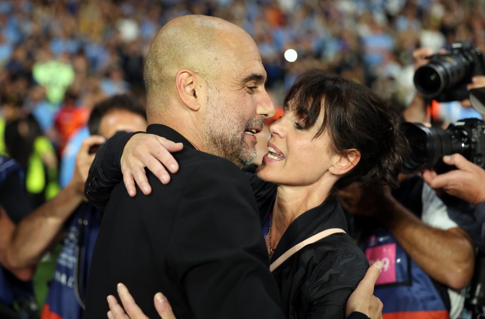 Pep Guardiola kissing his wife after Manchester City won the UEFA Champions League.