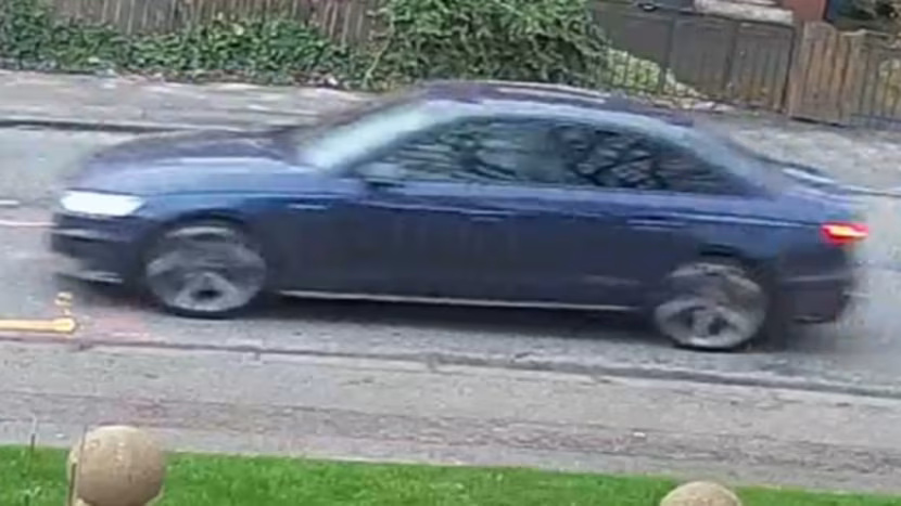 Blue Audi A4 (BV21 WZL) driving on a residential street.