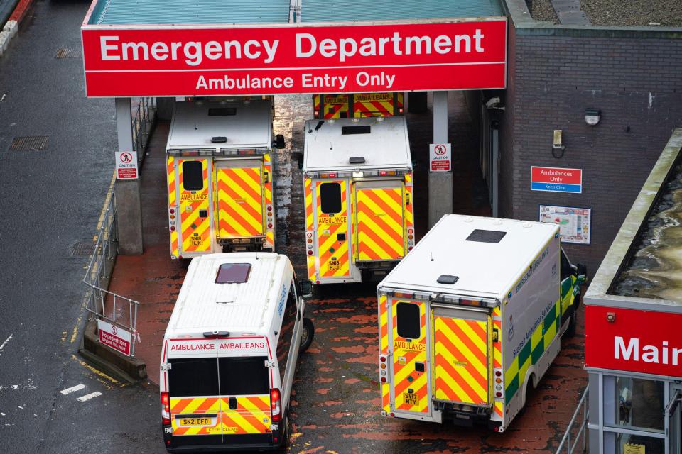 Ambulances waiting to unload patients at a hospital emergency department.