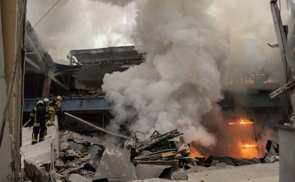 Firefighters battling a fire at a damaged civilian factory in Kharkiv, Ukraine.