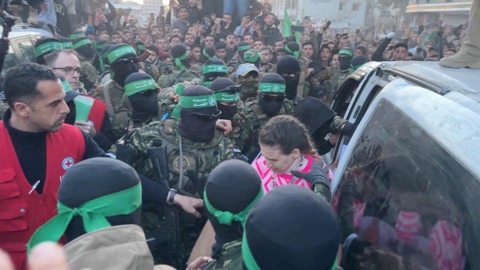 Hamas militants handing over hostages to the ICRC in Gaza City.