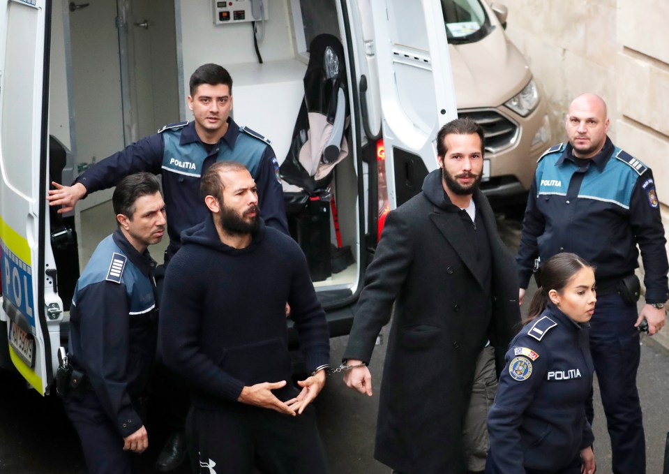 Andrew Tate and his brother Tristan Tate in handcuffs at a Bucharest court hearing.