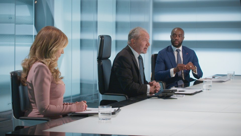 Lord Sugar, Baroness Karren Brady, and Tim Campbell in a boardroom.