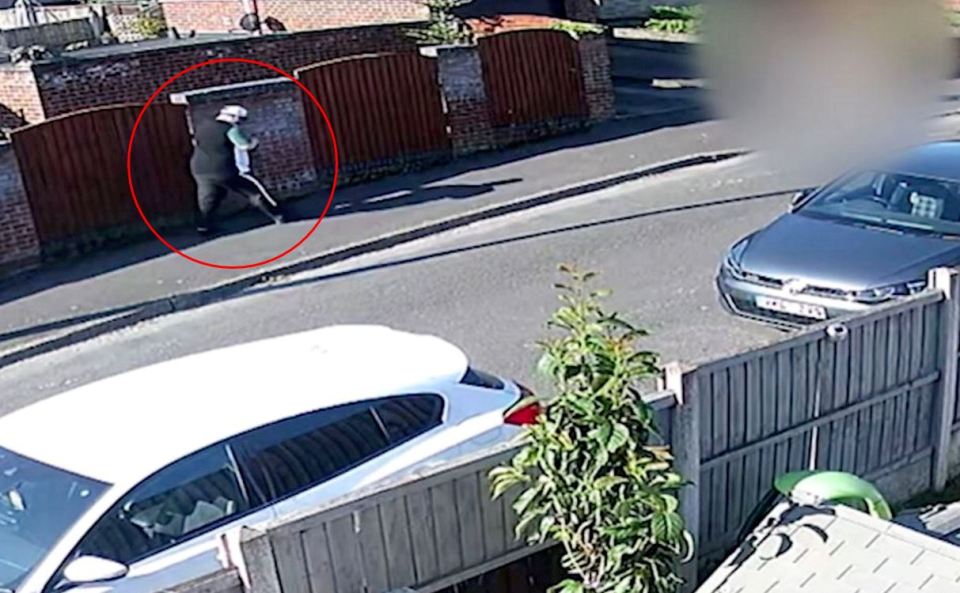 CCTV image of a man following a woman on a street.