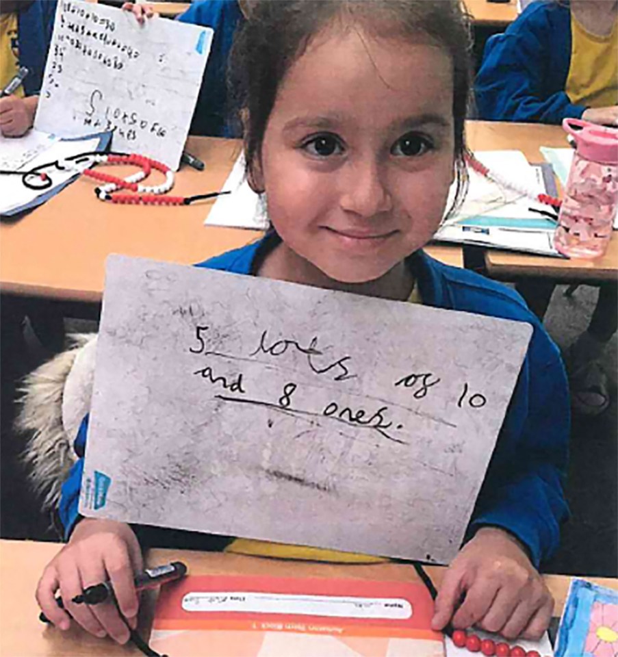 Photo of Sara Sharif holding a whiteboard with math problem.