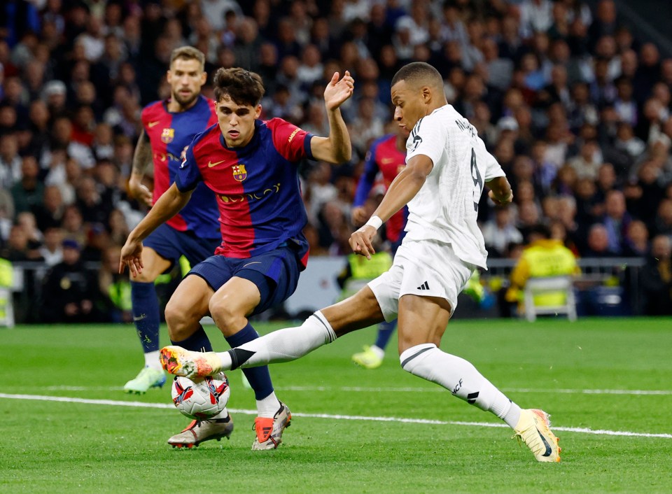 Kylian Mbappé of Real Madrid in action against a FC Barcelona player.