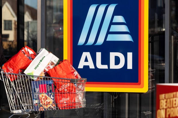 Shopping cart full of groceries outside an Aldi supermarket.