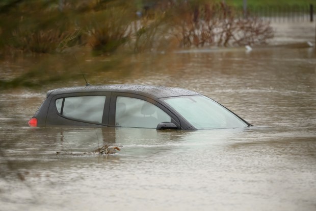 Submerged car in floodwaters.