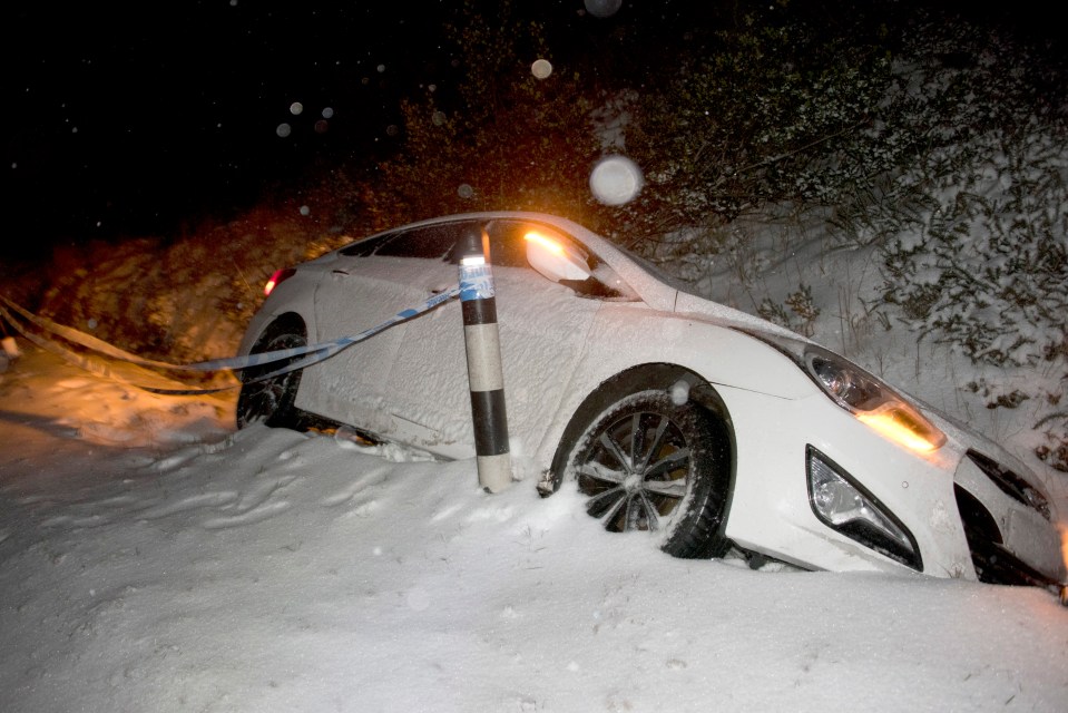 A car slides off the road as a blizzard hits the Brecon Beacons National Park in Powys