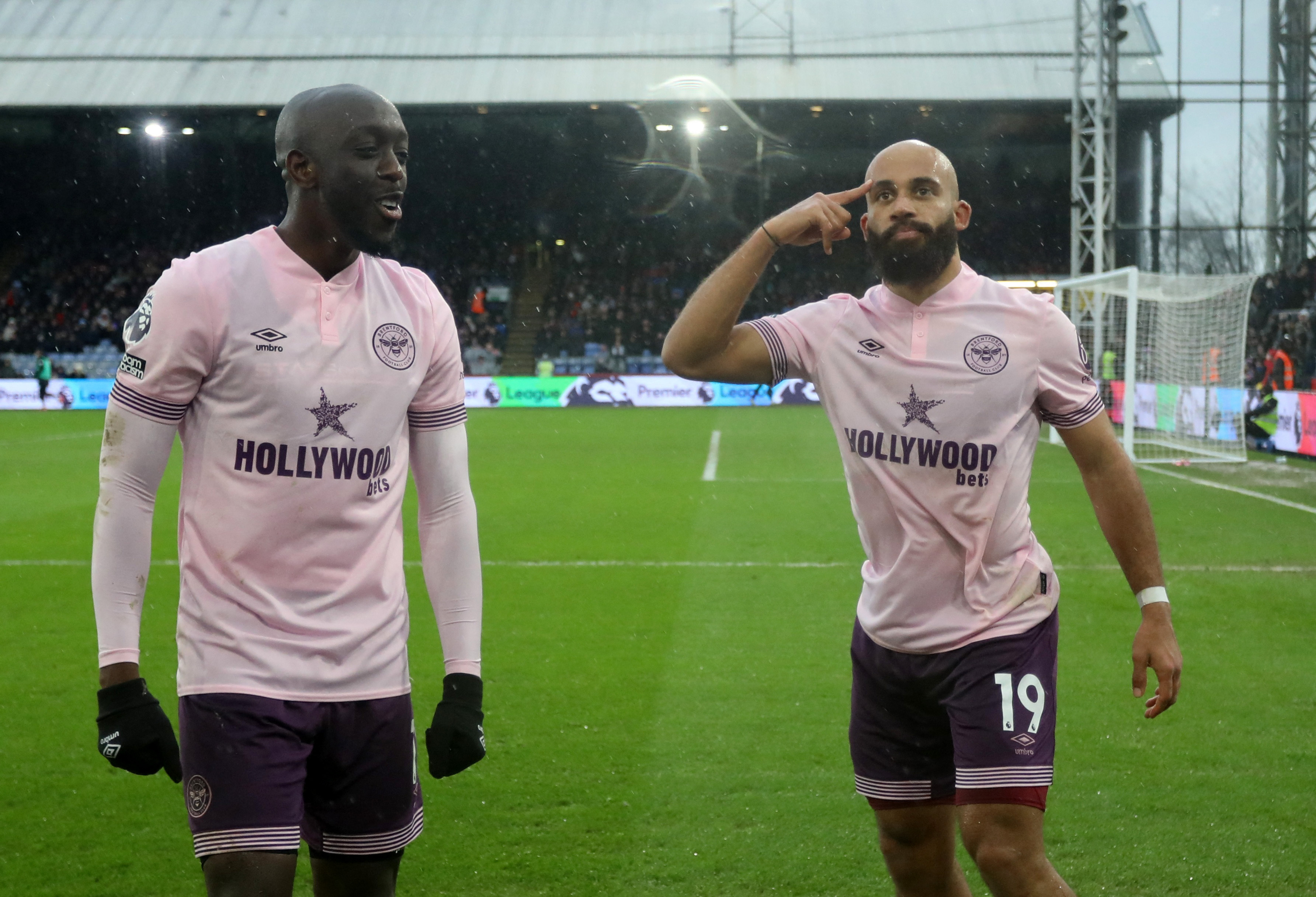 Brentford players Bryan Mbeumo and Yoane Wissa celebrating a goal.