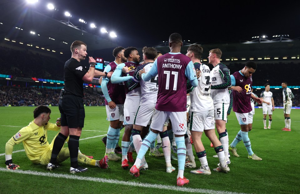 Burnley's James Trafford reacts to an injury during a soccer match.