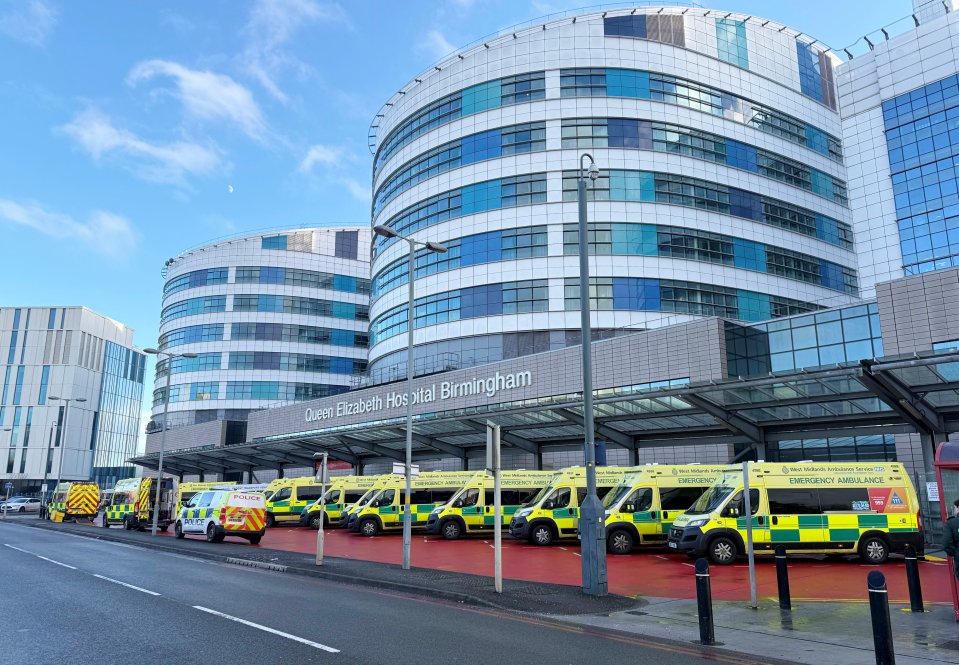 Multiple ambulances parked outside Queen Elizabeth Hospital Birmingham during a critical incident.