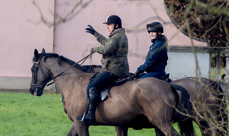 Prince Andrew and another person horseback riding.