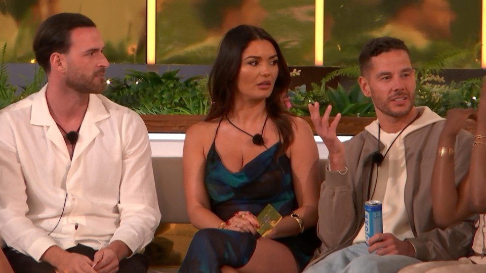 Three Love Island contestants at a firepit game.