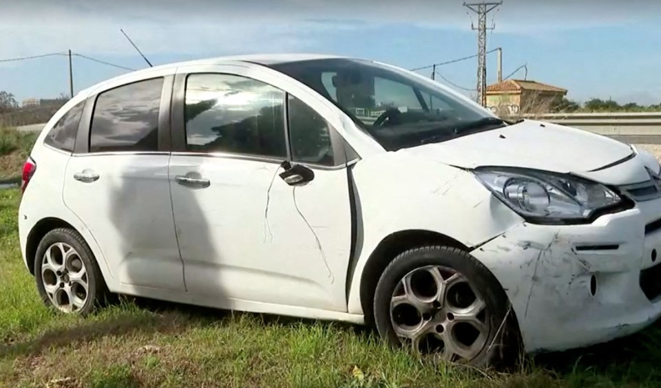 Damaged white car involved in a cycling accident.