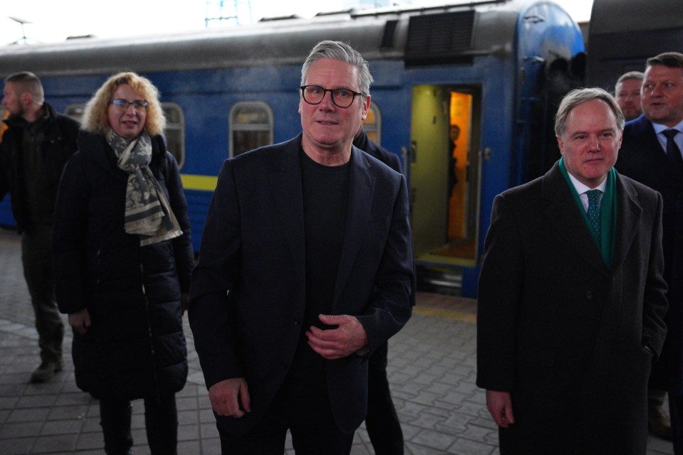 Keir Starmer, British Prime Minister, arriving at Kyiv train station, greeted by Ukrainian officials.