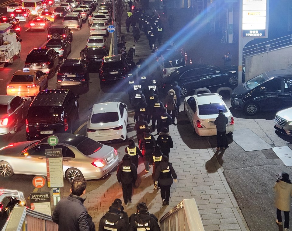 Police officers near the residence of impeached South Korean President Yoon Suk Yeol.