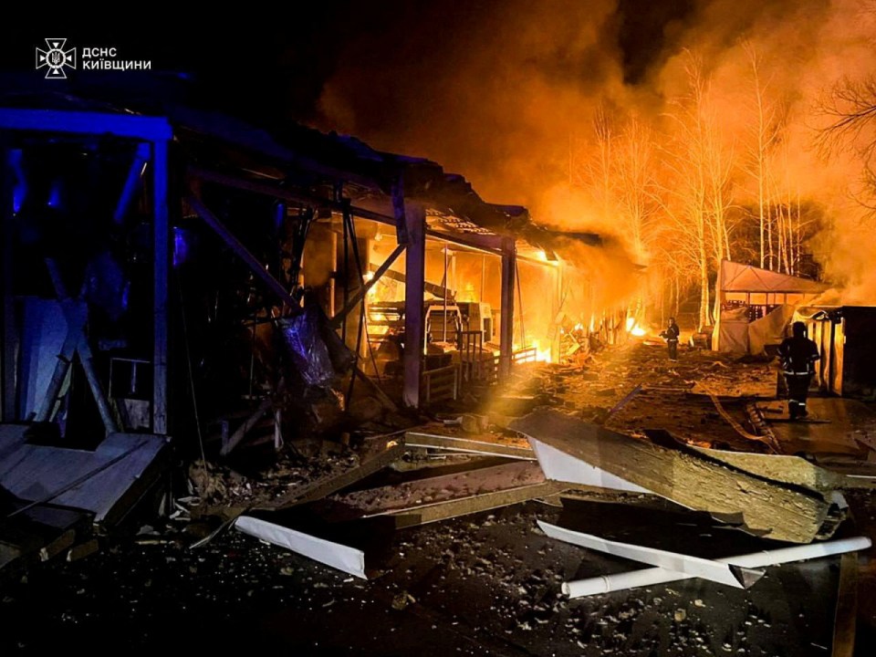 Firefighters at the site of a Russian drone strike in Kyiv.