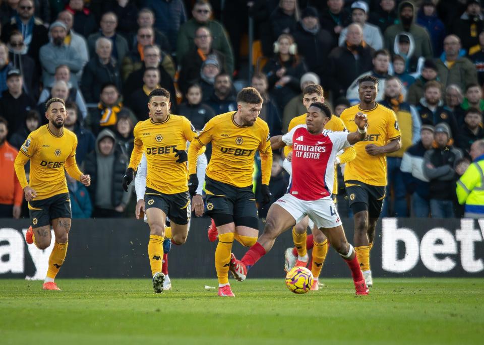 Arsenal player Myles Lewis-Skelly receives a red card for fouling a Wolverhampton Wanderers player.