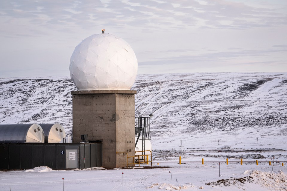 Radar dome at a snowy facility.