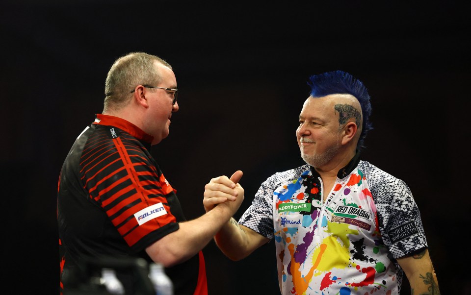 Stephen Bunting and Peter Wright shaking hands after a darts match.