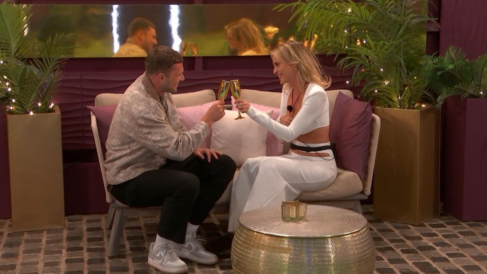 Sammy and Danielle, two new contestants, toasting on Love Island.