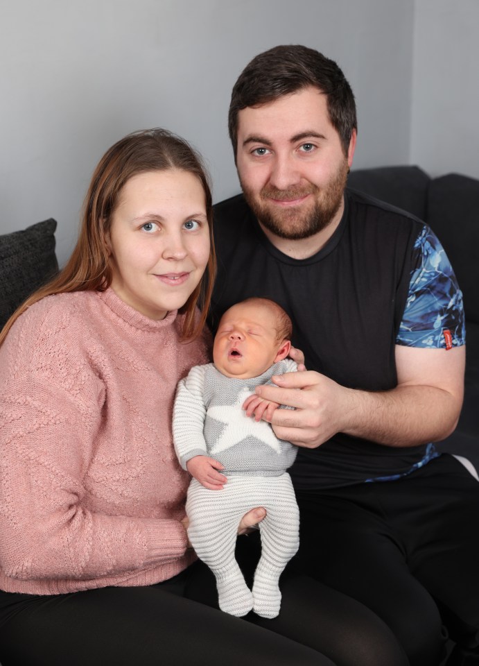 Parents holding their newborn baby.