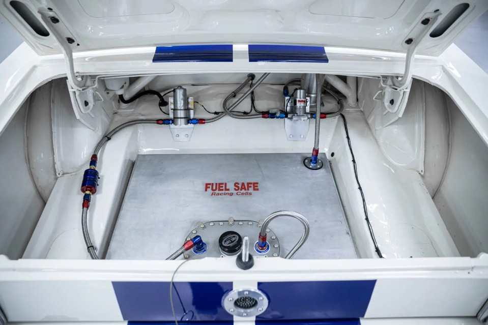 Fuel cell and fuel system in the trunk of a classic Ford Mustang.