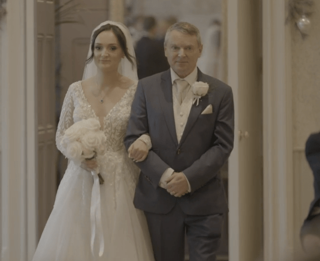 Bride and father walking down aisle.