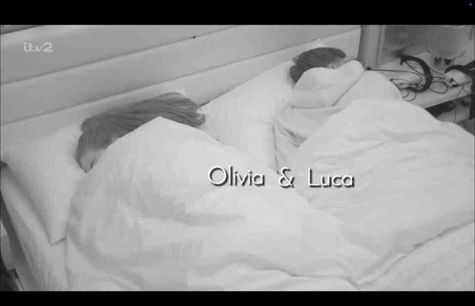 Olivia and Luca asleep under covers.