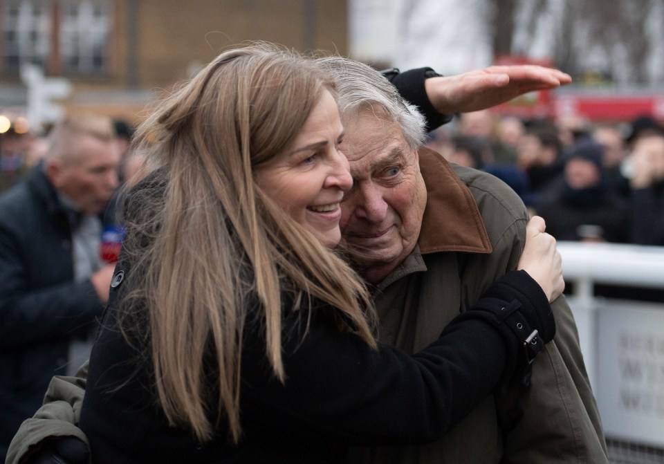 Owner John Hales embracing a woman after a horse race win.