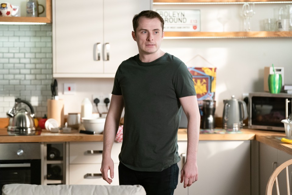 Max Bowden as Ben Mitchell in a kitchen.