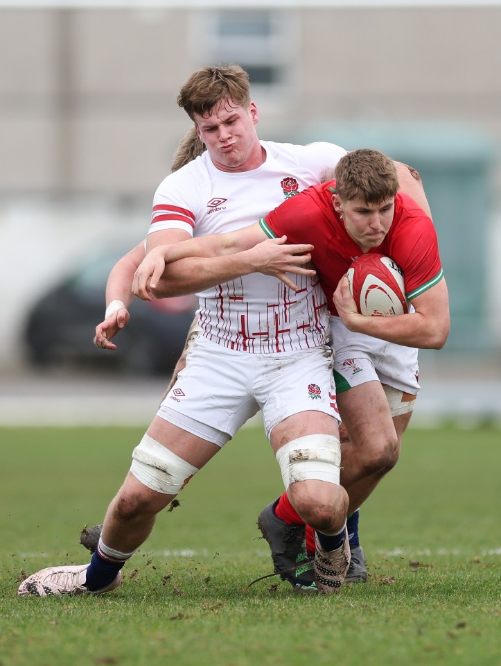 Steffan Emanuel of Wales tackling Reuben Logan and Jack Bennett of England during a rugby match.