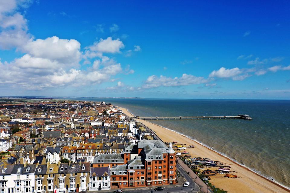 Aerial view of Deal, Kent, UK, showing the town, beach, and pier.