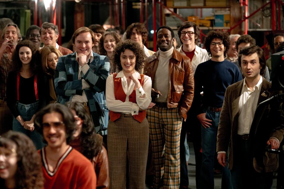 A group of people in 1970s attire.