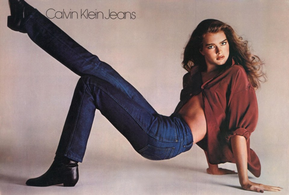 Calvin Klein Jeans advertisement featuring a woman in jeans and a shirt.