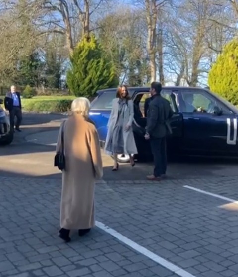 Woman exiting a car.