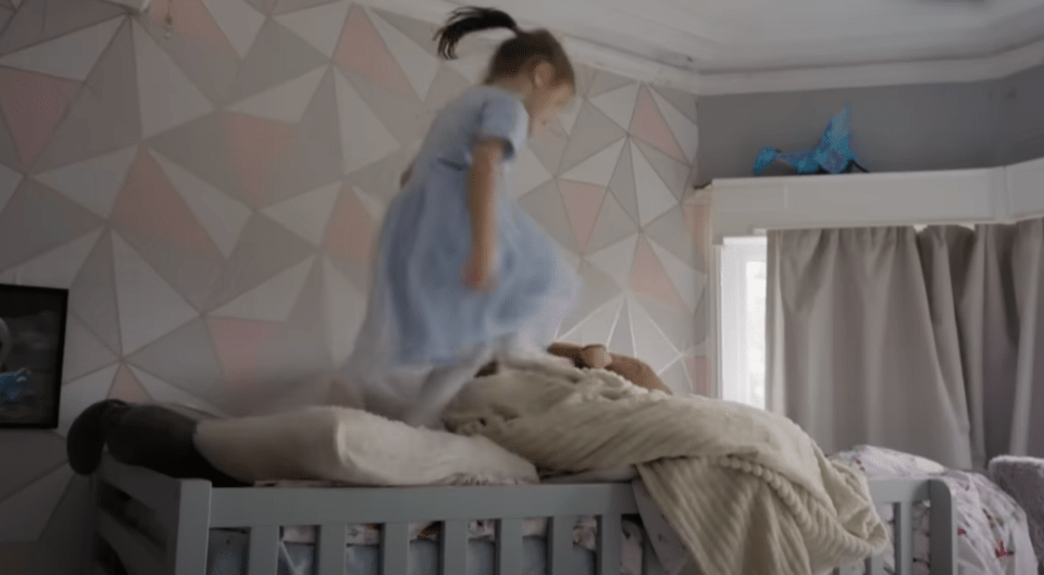 Girl jumping on a bed.