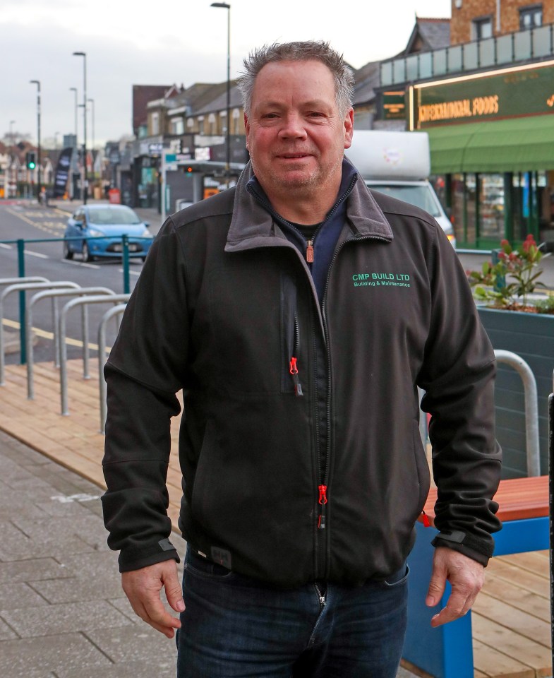 Man in CMP Build LTD jacket on Portswood Road, Southampton.