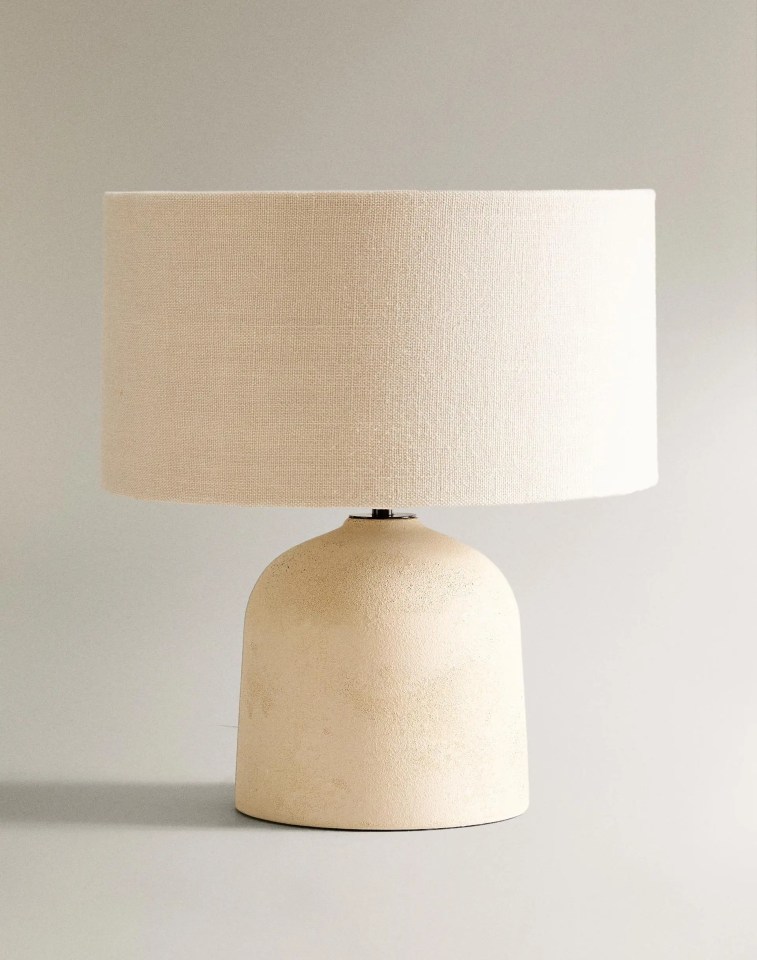 Beige table lamp with a fabric shade.