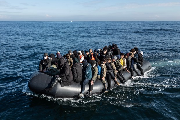 Migrants in a small inflatable boat crossing the English Channel.