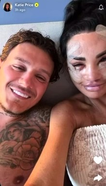 Katie Price and a man in a selfie, Katie has face bandages.