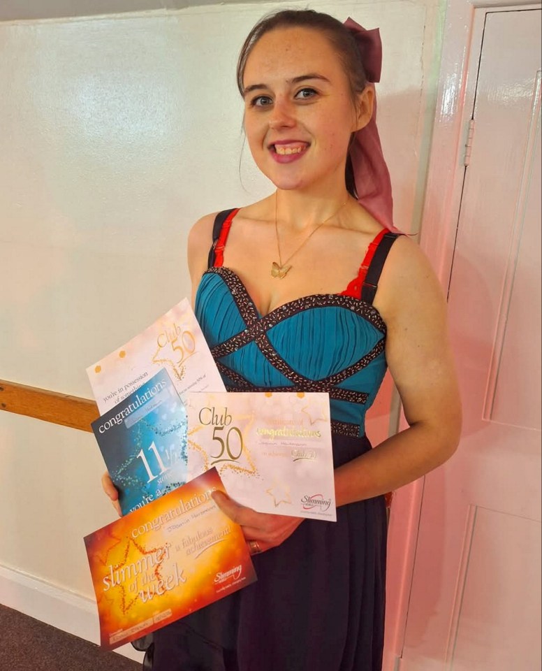 Woman holding Slimming World awards.