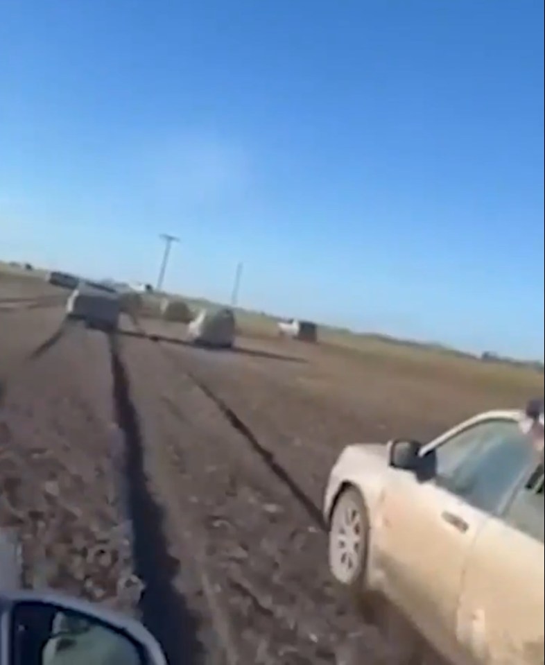 Cars driving on a muddy road.